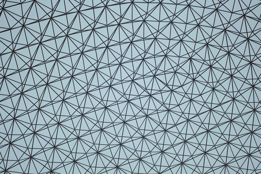 Close-up of a large origami tessellation structure with many lines, showcasing a complex geometric pattern in diamond symmetry. — base photo: A macro view of a large, detailed origami tessellation structure. The complex network of lines and f