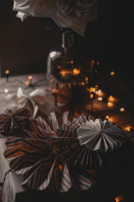 Seamless mirror wallpaper pattern — Origami by wallpaper⁶ — base photo: Heap of creative decorations made of paper placed on table with glowing lights and vase in room with