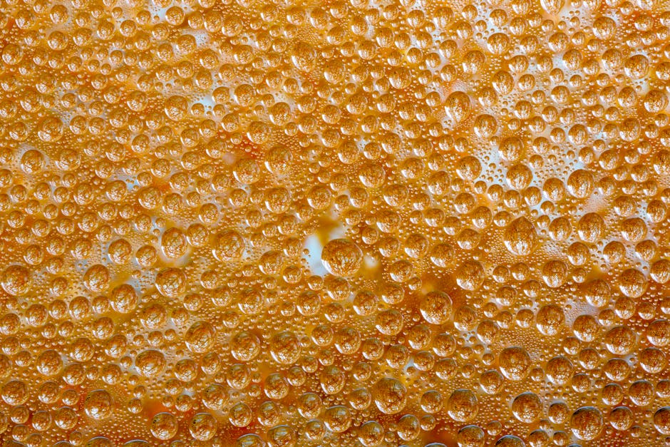 Seamless mirror wallpaper pattern — Biochemistry by wallpaper⁶ — base photo: Macro shot of dew droplets on an orange-colored textured surface, creating a vibrant pattern.