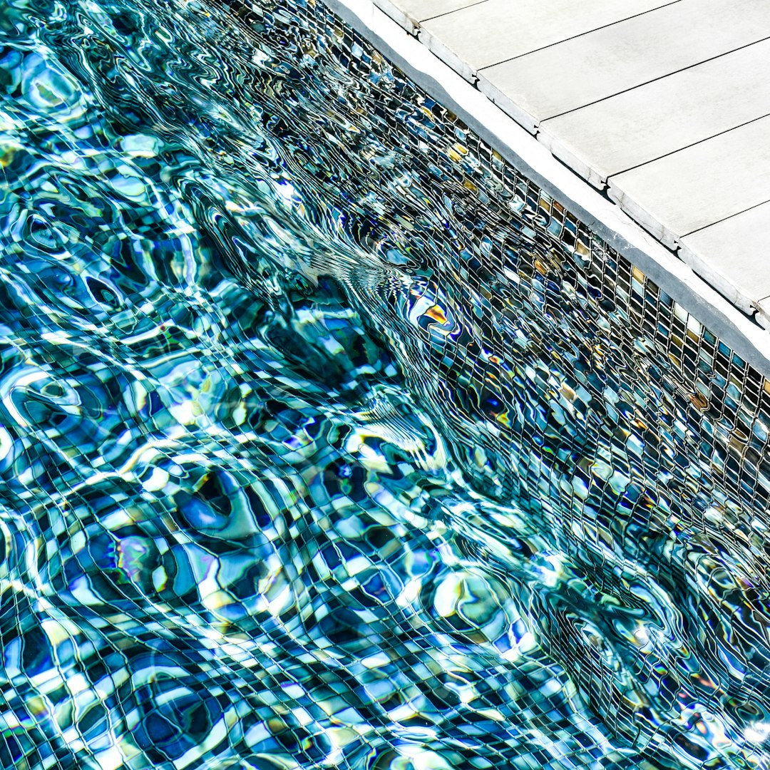 Seamless pinwheel wallpaper pattern — Stained Glass by wallpaper⁶ — base photo: on the edge of a tiled swimming pool