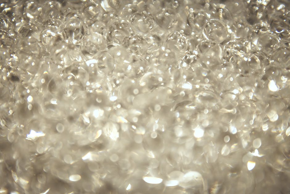 Chemistry Mirror wallpaper pattern — base photo: Close-up view of sparkling transparent crystal beads with bokeh effect.