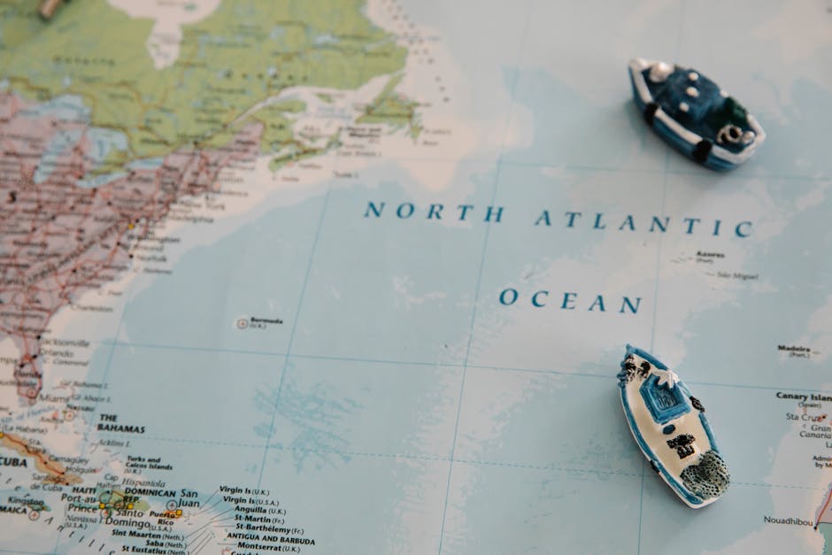 Seamless mirror wallpaper pattern — Cartography by wallpaper⁶ — base photo: Miniature ships placed on a detailed map of the North Atlantic Ocean.