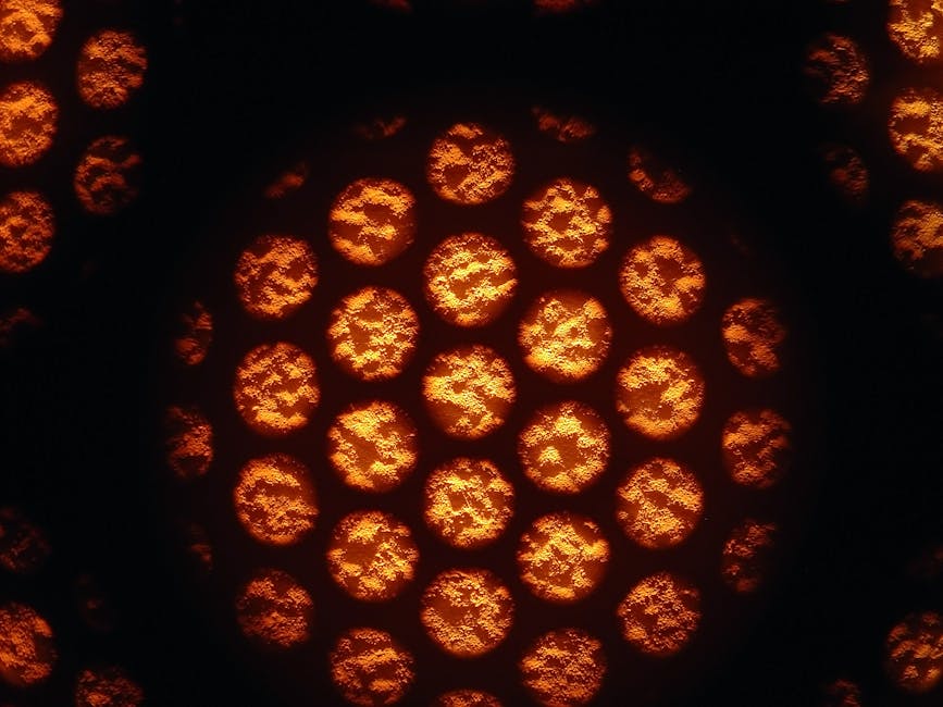 Biology Kaleidoscope wallpaper pattern — base photo: Illuminated circular patterns creating an abstract glowing texture with an orange hue.