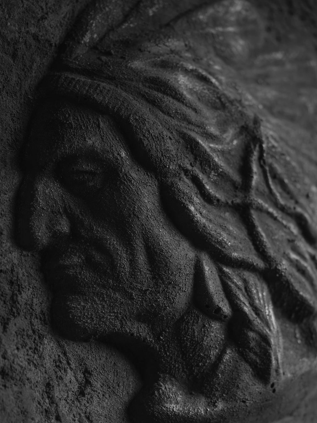 Portraits Mirror wallpaper pattern — base photo: A carved relief of a native american chief's profile.