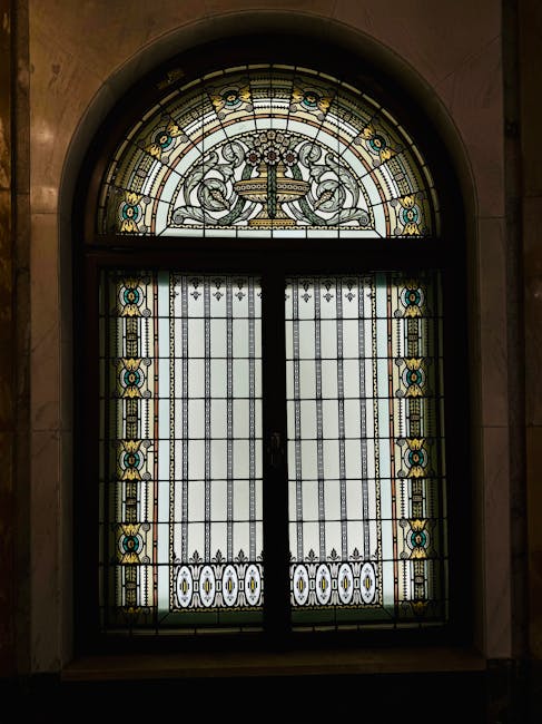 Close-up of geometric stained glass pattern with hex symmetry, featuring vibrant jewel tones and leaded lines, inspired by a traditional window. — base photo: A close-up view of a detailed stained glass window panel by Zsombi Burger, highlighting the leaded l