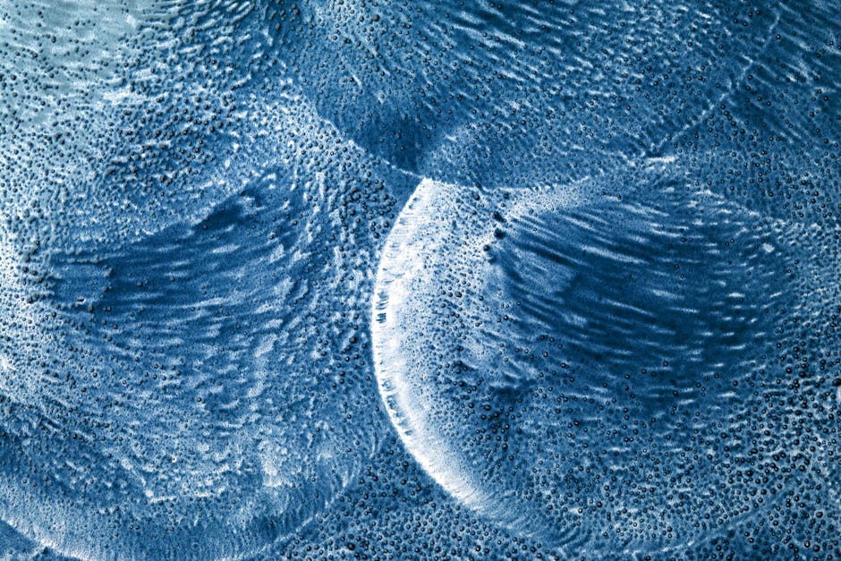 Seamless kaleidoscope wallpaper pattern — Biochemistry by wallpaper⁶ — base photo: Abstract close-up of textured blue ice patterns showing circle formations and intricate details.