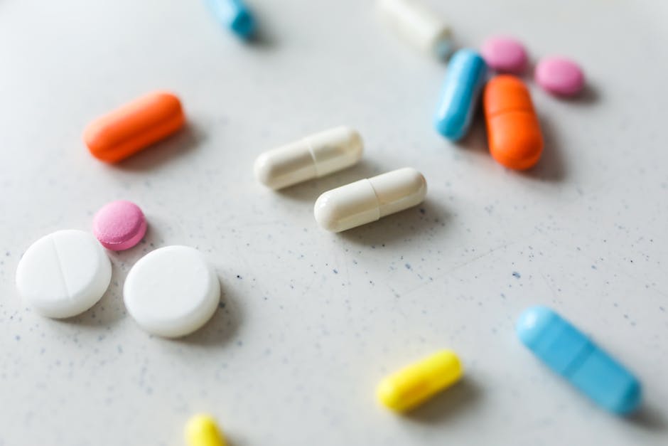 Seamless mirror wallpaper pattern — Biochemistry by wallpaper⁶ — base photo: Close-up view of assorted colorful pills and tablets scattered on a white surface.