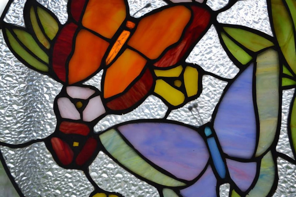 A mesmerizing kaleidoscope pattern created from the intricate details of leaded stained glass, with vibrant colors divided by dark lead lines. — base photo: A close-up view of a traditional stained glass window, showcasing the distinct metallic lead lines s
