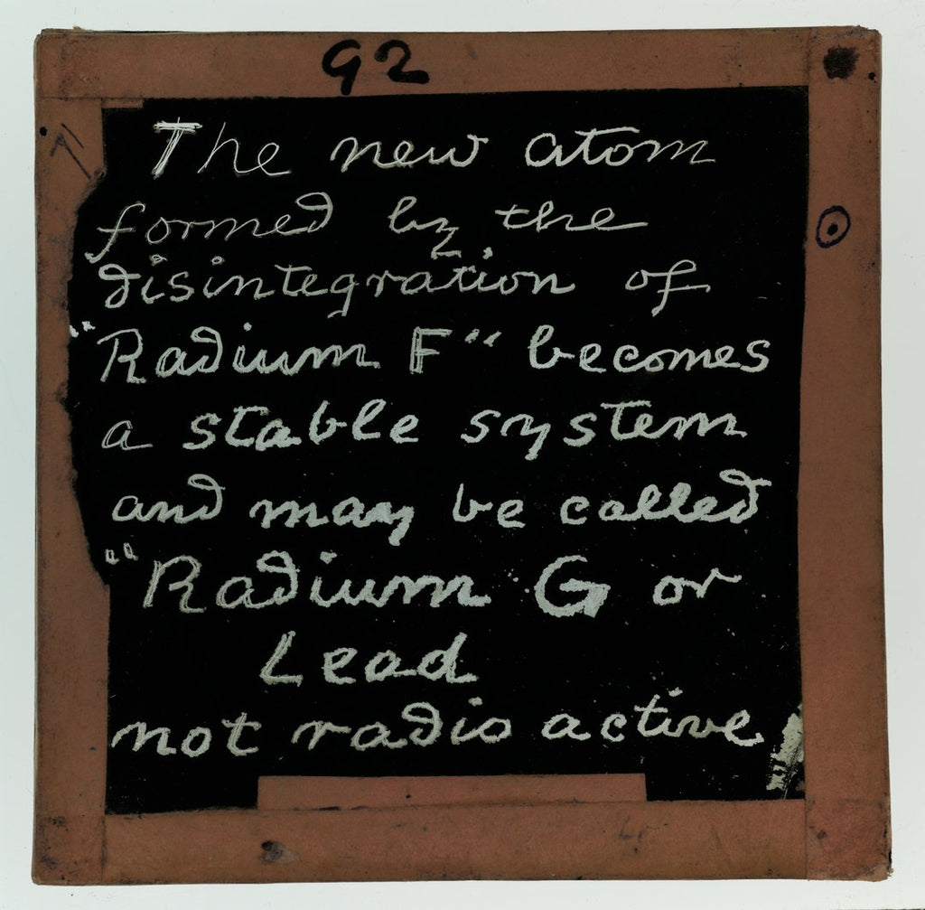 A seamless mirror symmetry pattern of vintage handwritten chemical equations and scientific text on a dark chalkboard background. — base photo: A turn-of-the-century glass lantern slide from the Clement Lindley Wragge collection detailing the r