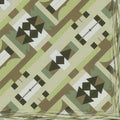 Abstract geometric origami motifs arranged in a repeating diamond symmetry pattern on wallpaper.