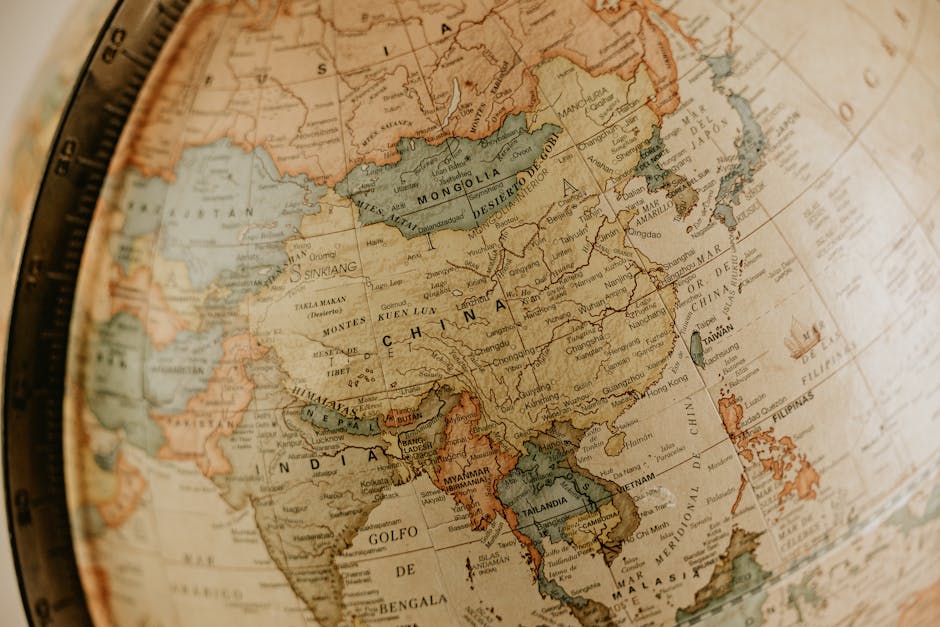 Seamless mirror wallpaper pattern — Cartography by wallpaper⁶ — base photo: Detailed vintage globe map highlighting Asia, featuring countries like China and India.