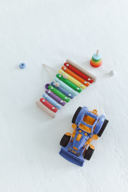 Seamless kaleidoscope wallpaper pattern — Arithmetic by wallpaper⁶ — base photo: A vibrant toy xylophone and a blue toy car positioned on a white surface, perfect for children's the