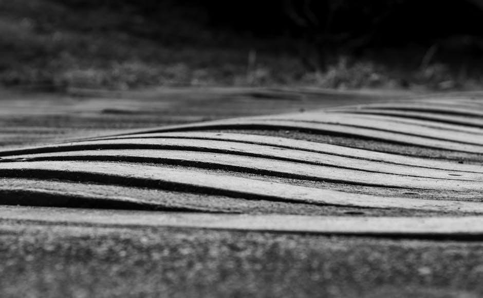 Seamless kaleidoscope wallpaper pattern — Glitch by wallpaper⁶ — base photo: Black and white abstract image of wave-like patterns on a textured surface in Bahia, Brasil.