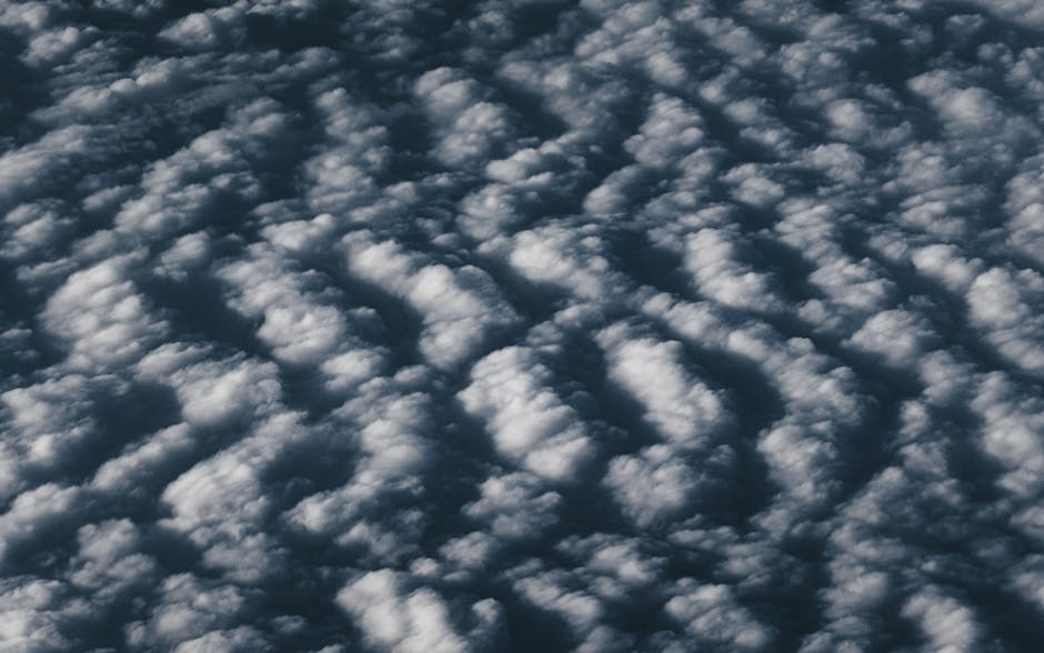 Meteorology Wave wallpaper pattern — base photo: A captivating aerial view of textured clouds forming an abstract cloudscape pattern.